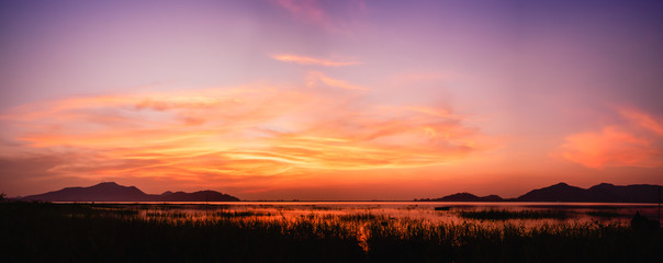 panoramic view of sunset above the lake with twilight sky