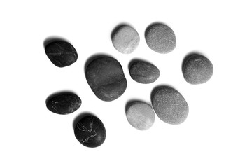 Sea pebbles. Heap of smooth gray and black stones isolated on white background, top view