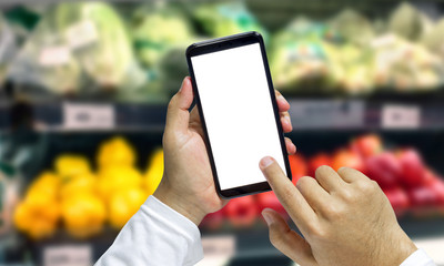 Shopper Mobile smart phone in hand, and see more detail and compare the prices in supermarkets.