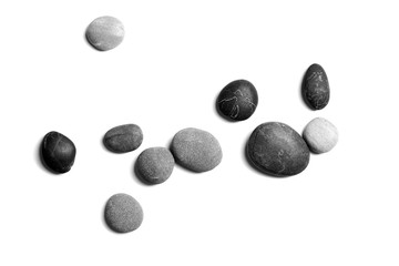 Fototapeta na wymiar Sea pebbles. Heap of smooth gray and black stones isolated on white background, top view