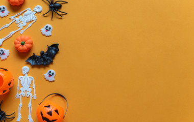 Halloween holiday concept, Pumpkin, bats, white skeleton and tiny ghost in orange background with copy space for text, Top flat view wallpaper