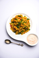 Broken wheat or Daliya Upma, served in a bowl. selective focus