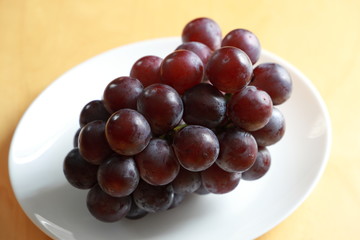 Black grapes on white background