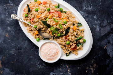Broken wheat or Daliya Upma, served in a bowl. selective focus