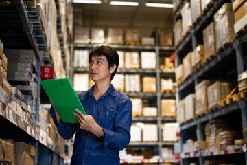 Manager man worker doing stocktaking of product management in cardboard box on shelves in warehouse. Physical inventory count.. Male professional assistant checking stock in factory.