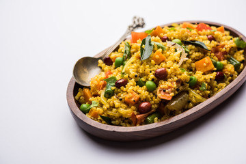Broken wheat or Daliya Upma, served in a bowl. selective focus