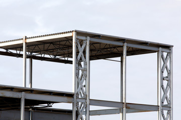 Steel girder construction for an industrial building against a clear light sky