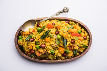 Broken wheat or Daliya Upma, served in a bowl. selective focus