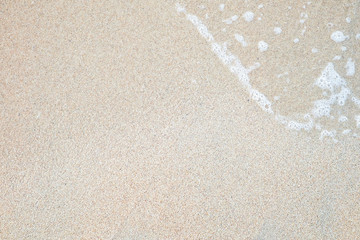 Sand and wave on the beach background for you design.