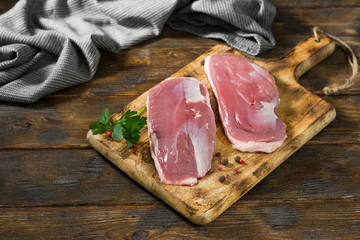 Raw duck meat on a wooden Board. Top view