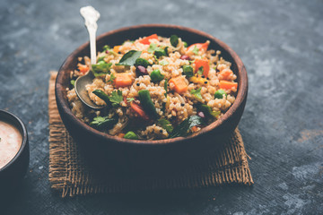 Broken wheat or Daliya Upma, served in a bowl. selective focus