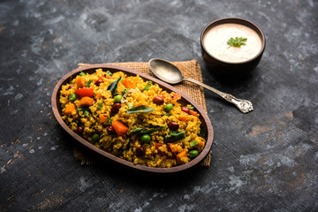 Broken wheat or Daliya Upma, served in a bowl. selective focus