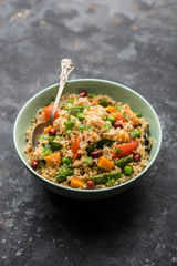 Broken wheat or Daliya Upma, served in a bowl. selective focus
