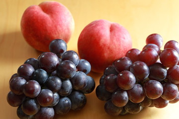 Peaches and black grapes on the table