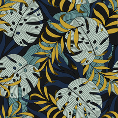 Fashionable seamless tropical pattern with bright white and yellow leaves and plants on black background. Beautiful print with hand drawn exotic plants. Colorful stylish floral.