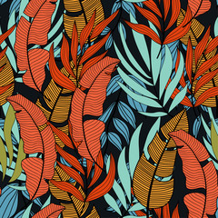 Summer seamless tropical pattern with bright leaves and plants on a black background. Summer colorful hawaiian seamless pattern with tropical plants. Exotic wallpaper.