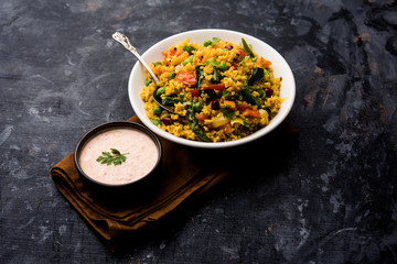Broken wheat or Daliya Upma, served in a bowl. selective focus
