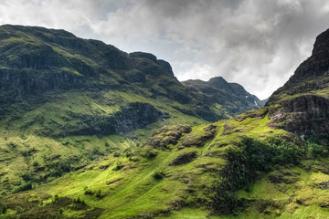 Fototapeta na wymiar Amazing mountains surrounding Glencoe valley on a sunny day, Highlands, Scotland, UK