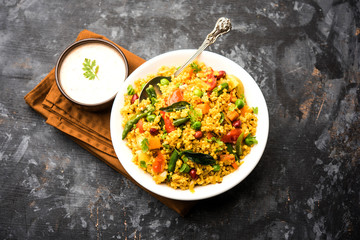 Broken wheat or Daliya Upma, served in a bowl. selective focus