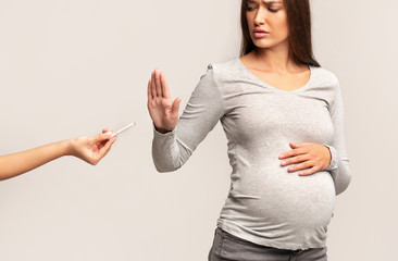 Pregnant Woman Gesturing Stop Refusing Take Cigarette Standing In Studio