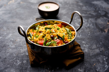 Broken wheat or Daliya Upma, served in a bowl. selective focus