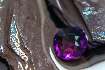 Vintage jewel or gems shine on the rough stone and water background. close up.