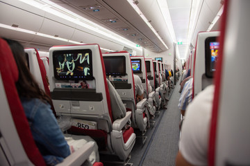 Interior of airplane flight with passengers on seats