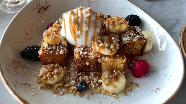 French toast bananas and berries with ice cream , breakfast in restaurant ,