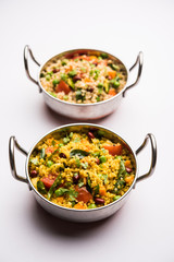 Broken wheat or Daliya Upma, served in a bowl. selective focus