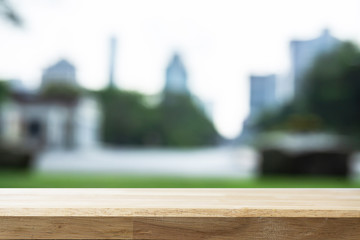Empty wooden Brown table and blurred garden bokeh background. Mock up for display or montage of product,Business presentation.