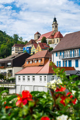 Germany, Beautiful church and old town of city horb am neckar on sunny day behind colorful red...