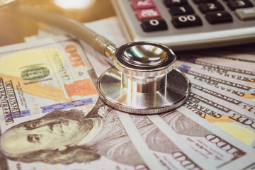 Health care costs. Stethoscope and calculator symbol for health care costs or medical insurance 