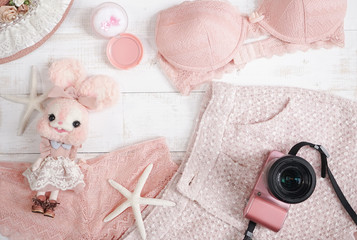 Top view of essential modern young lady or girl on vacations.Woman's summer holiday accessories composed on pastel pink color background. Beach fashion , summer concept. pastel pink colors.