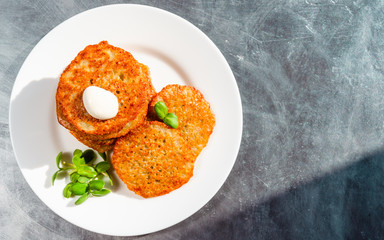 Homemade potato pancakes, latkes, draniki, hash browns or fritters served with sour cream and...