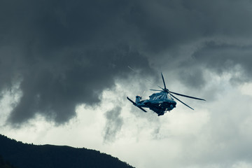 Fototapeta na wymiar Elicottero militare AW149 in volo in cielo tempestoso