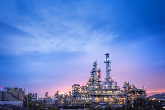Oil and gas refinery plant or petrochemical industry on blue sky sunset background, Factory at twilight time, Gas furnace and smoke stack in petrochemical industrial
