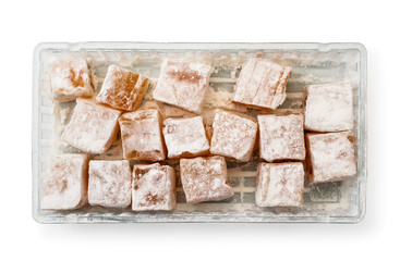 Sweets turkish delight in a box on a white. The view of the top.