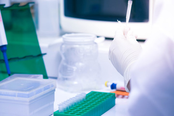 scientist using auto-pipette with Eppendorf consumables tube in the lab,Doing experiment for product,The researchers analyzed to find the results of the experiment.