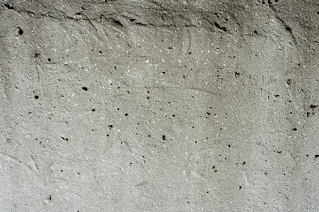 Texture of gray concrete stone wall in sunlight for pattern, background or 3D. Horizontal, close up