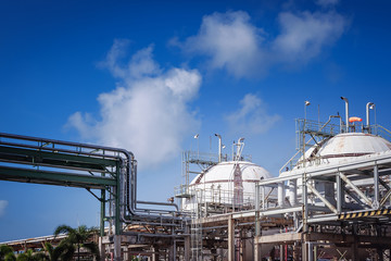 Fototapeta na wymiar Industrial plant on blue sky with white cloud, Gas storage and pipeline