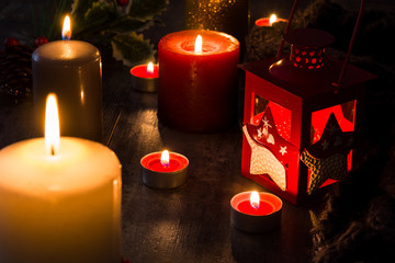 Christmas candles on wooden table. Dim light. Copy space