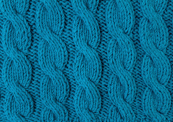Texture of turquoise knitted fabric close up