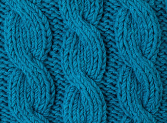Texture of turquoise knitted fabric close up