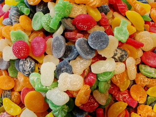 Assorted multicolored gummy candies closeup abstract background pattern. Macro photo of colorful...