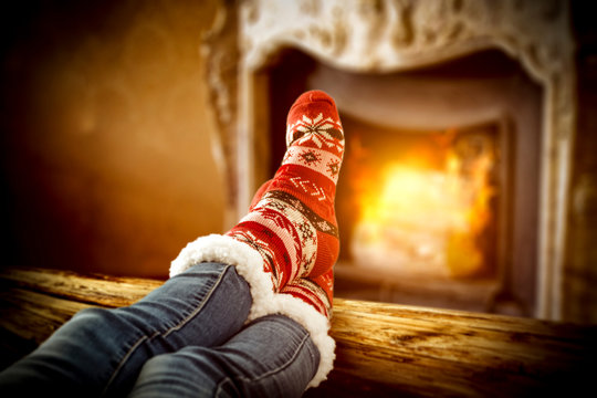 Retro fireplace and woan legs with christmas socks 