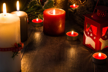 Christmas candles on wooden table. Dim light. Copy space