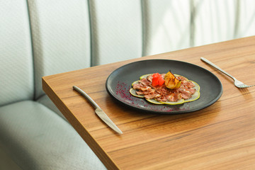 duck meat carpaccio with pear flambe (tasty snack, aperitif) menu concept. food background. copy space. Top view
