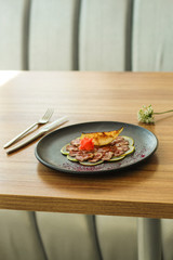 duck meat carpaccio with pear flambe (tasty snack, aperitif) menu concept. food background. copy space. Top view