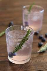 Gin summer cocktail seasonal with blueberry and rosemary