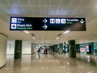 toilet exit baggage claim direction signs at the airport